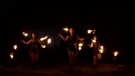 A-group-of-professional-artists-with-fire-show-the-show-juggling-and-dancing-with-fire-in-slow-motion